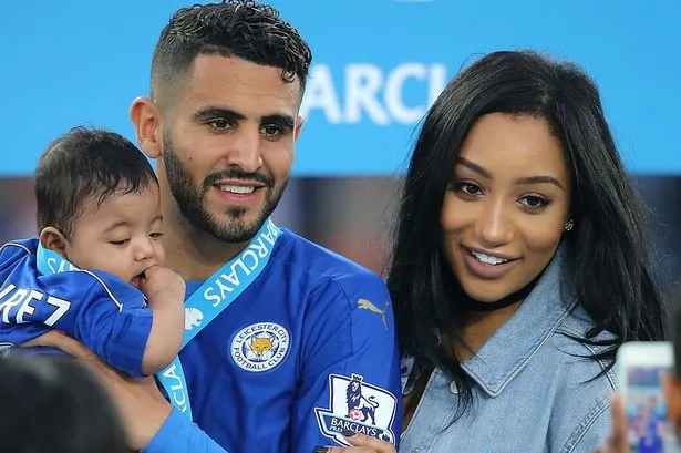 riyad-mahrez-of-leicester-city-holds-daughter-inaya-as-wife-rita-looks-on